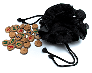 A black bag and some wooden discs with letters on them